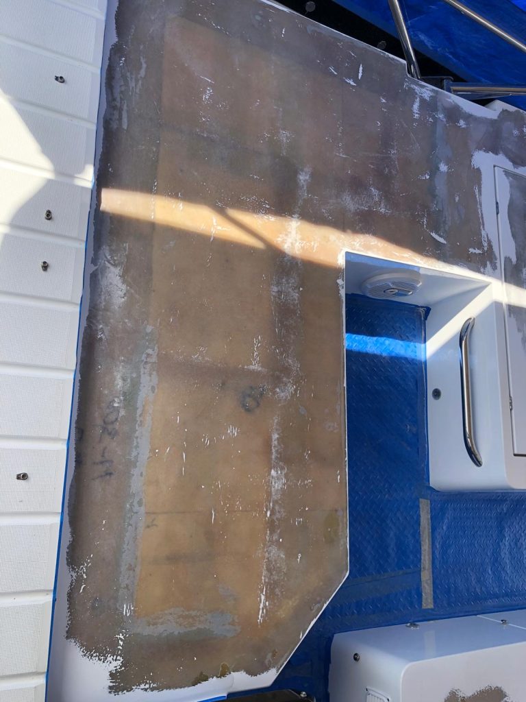 Boat deck section ground to bare laminate for structural fiberglass repair