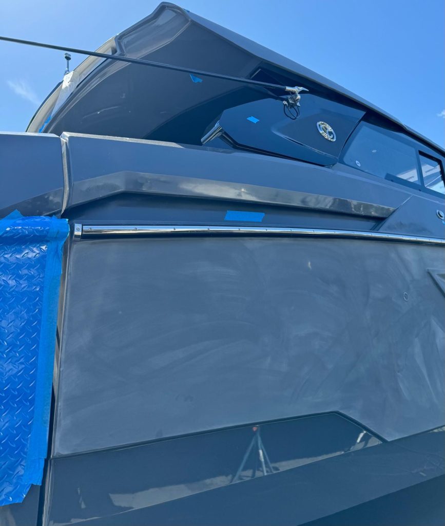 Gray yacht hull side sanded and prepped before paint application