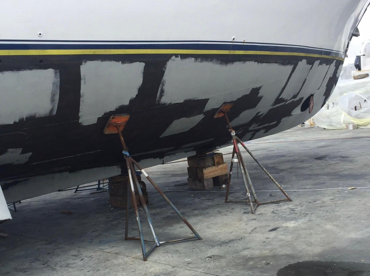 Yacht bottom with spot barrier coat primer patches before new bottom paint