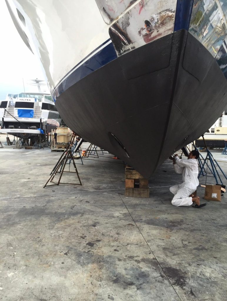 Yacht bow with fresh black antifouling bottom paint applied at the boatyard