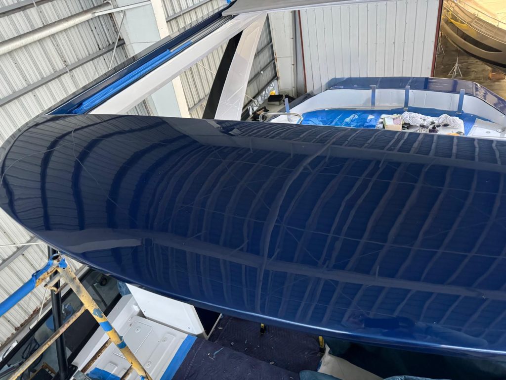 Yacht hardtop refinished in glossy navy blue paint
