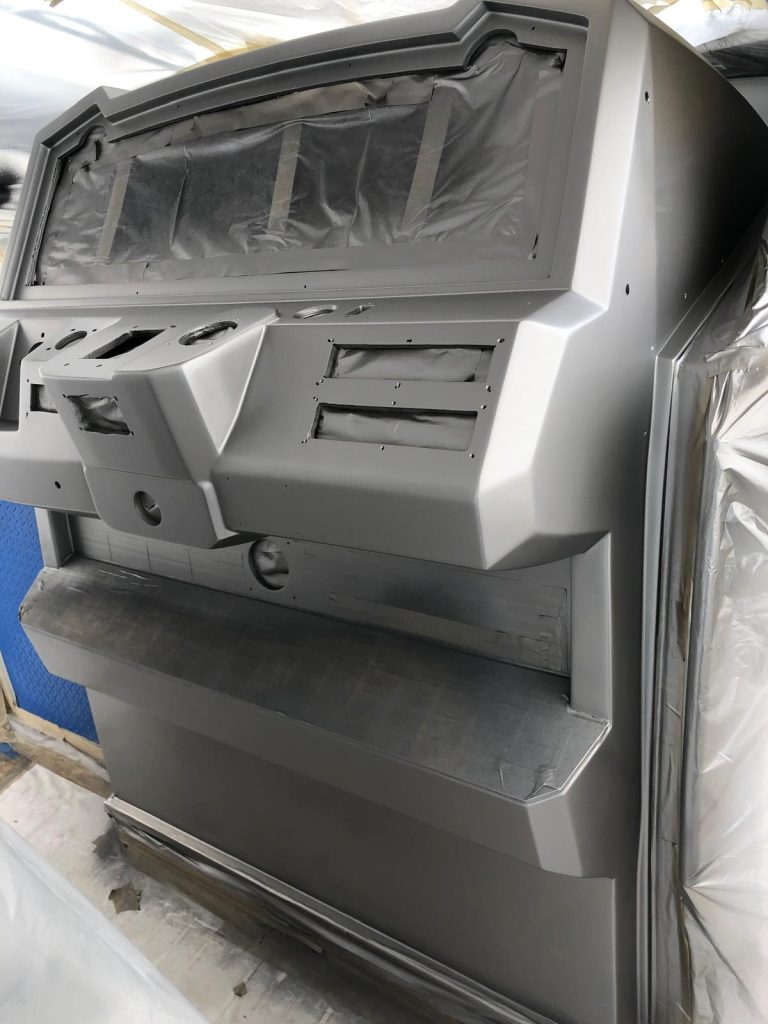Yacht helm console faired and primed in metallic silver, masked for painting in the shop